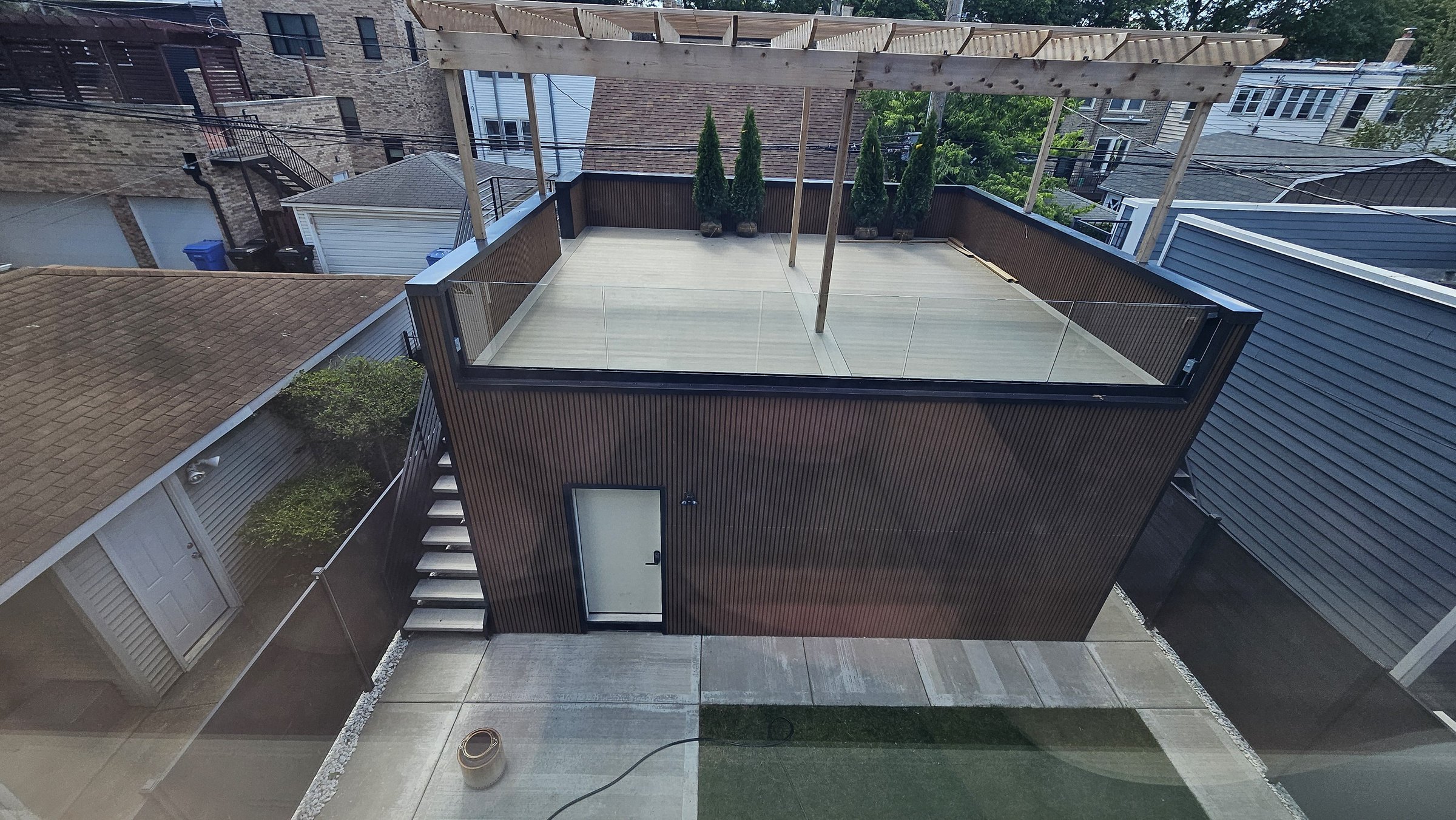 Garage roof deck with glass guard over fluted cladding